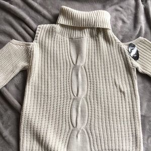 Turtle neck sweater with should cut outs.